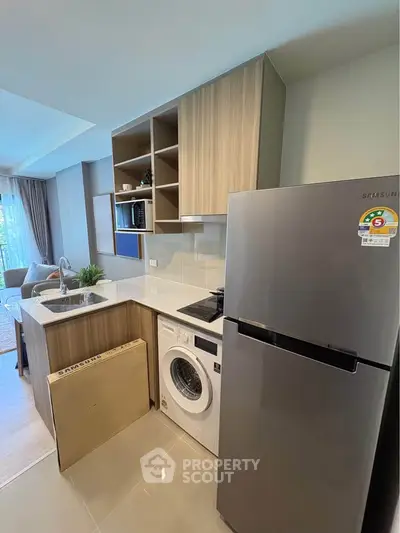 Modern kitchen with sleek appliances and open layout in stylish apartment