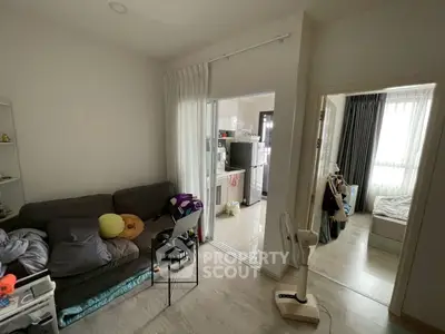 Cozy apartment interior with living room and bedroom, featuring modern decor and natural light.