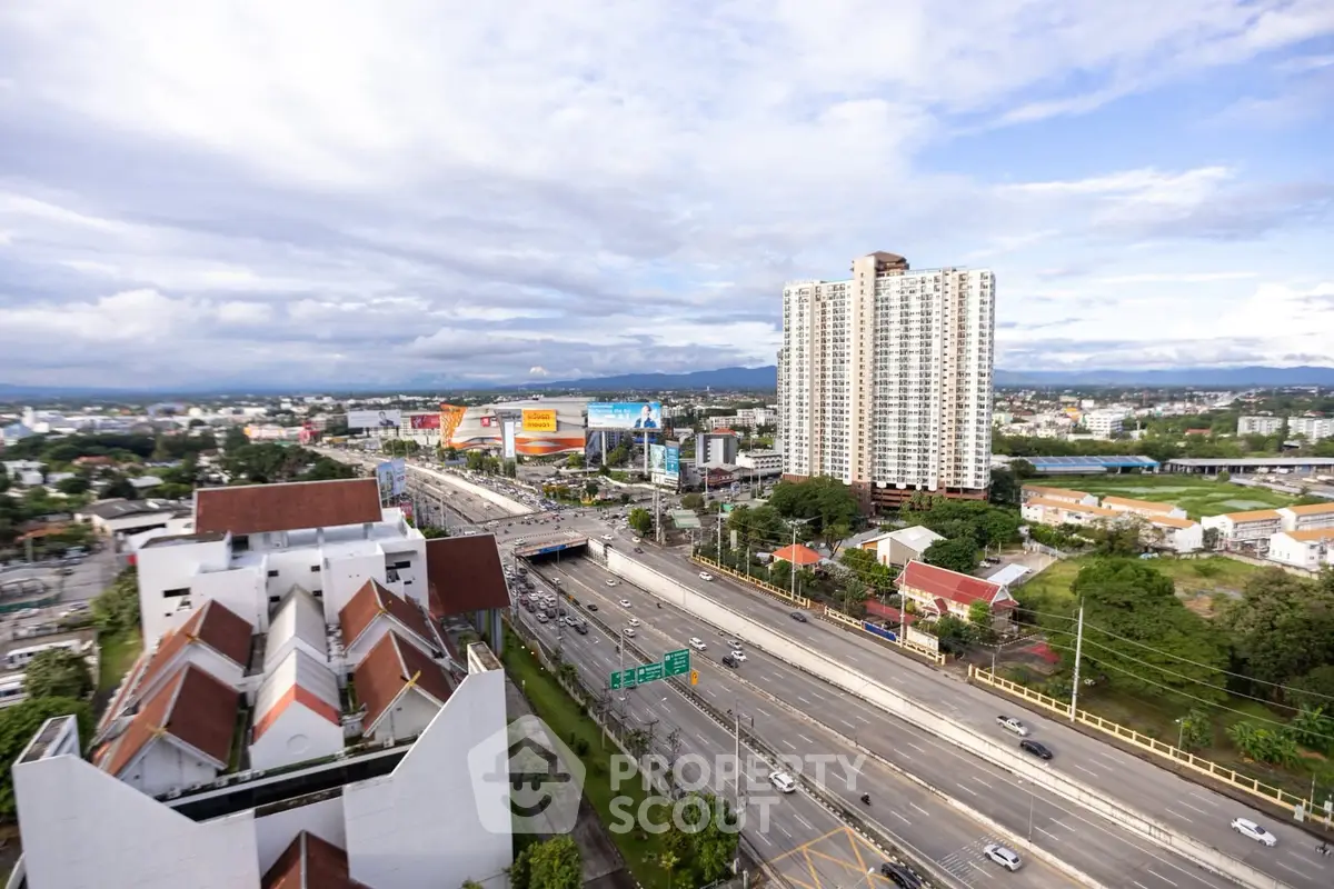 Stunning cityscape view with high-rise buildings and bustling highway, perfect for urban living.