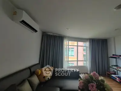 Cozy living room with modern air conditioning and plush sofa, perfect for relaxation.