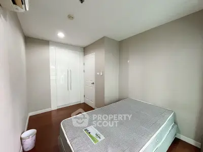 Spacious bedroom with modern wardrobe and cozy ambiance in a stylish apartment.