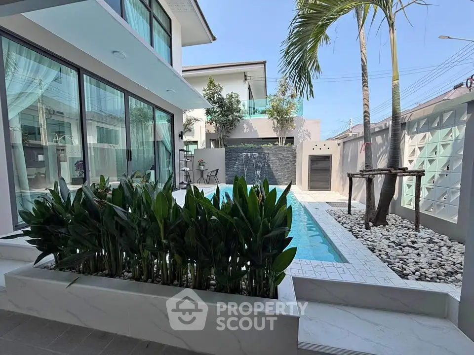 Luxurious modern home with private pool and lush garden, perfect for relaxation and entertaining.