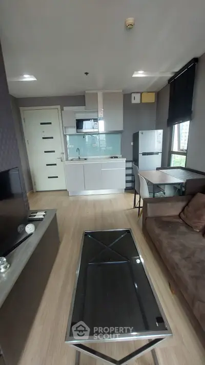 Modern living room with open kitchen layout and stylish furnishings