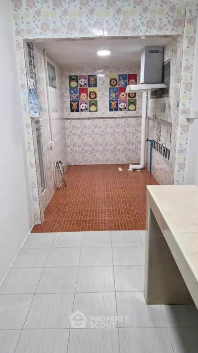 Charming kitchen space with colorful wall tiles and ample natural light, perfect for culinary creativity.
