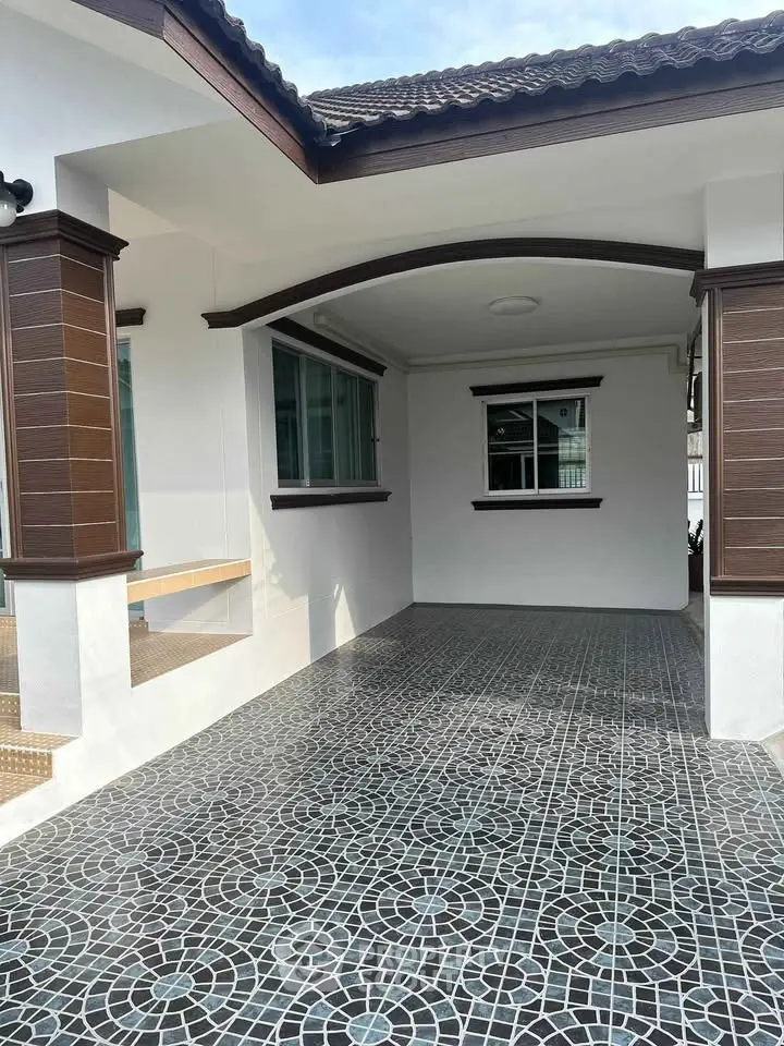 Charming home exterior with stylish tiled flooring and modern architectural details.