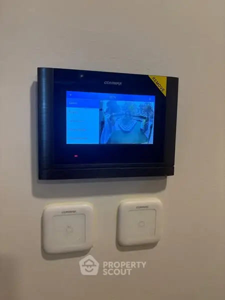 Modern home security system with CCTV display in a stylish interior setting.