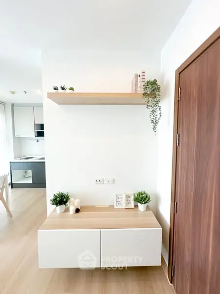 Modern minimalist interior with sleek wooden accents and open kitchen layout.