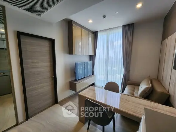 Modern living room with sleek furniture and large window view