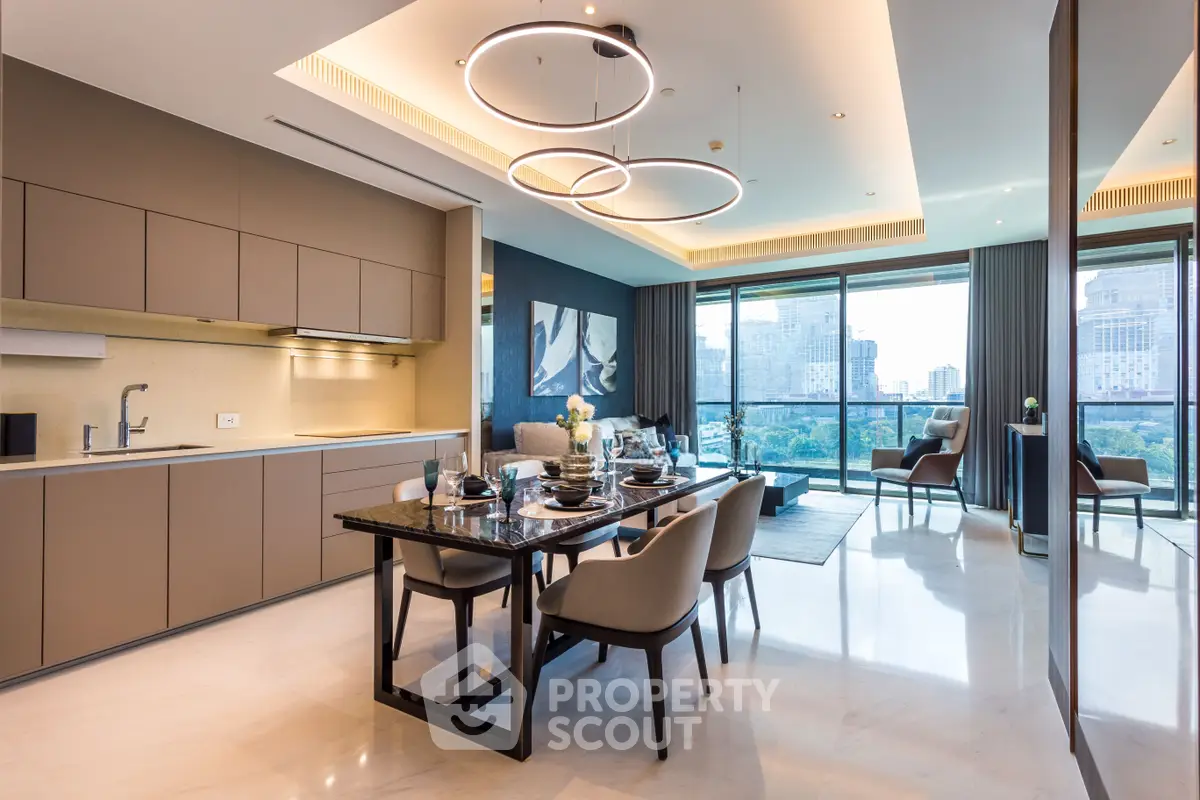 Luxurious open-plan living room with modern kitchen and stunning city view.