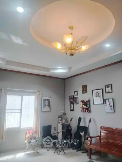 Charming living room with elegant chandelier and cozy seating area, perfect for relaxation and entertainment.