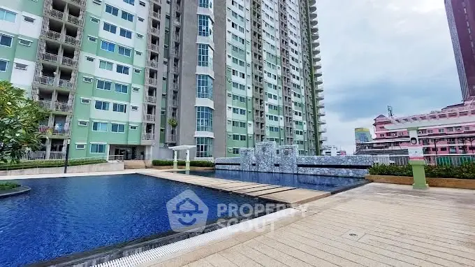 Modern high-rise building with luxurious pool and spacious deck area.