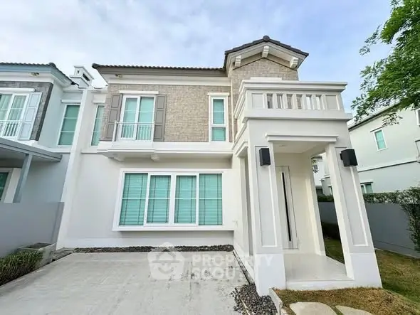 Elegant two-story house with modern facade and spacious driveway in a serene neighborhood.