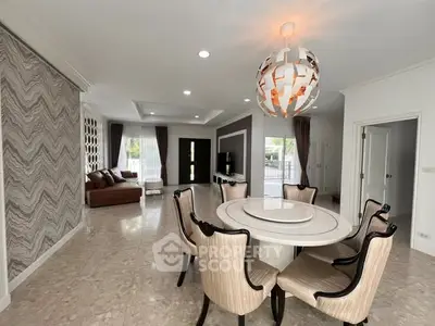 Spacious modern living room with elegant dining area and stylish lighting, perfect for entertaining guests.