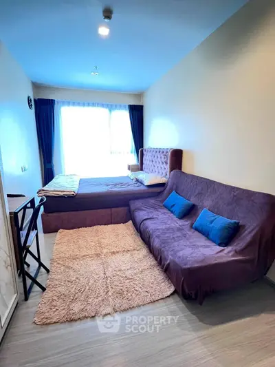 Cozy bedroom with stylish furniture and natural light, perfect for relaxation and comfort.
