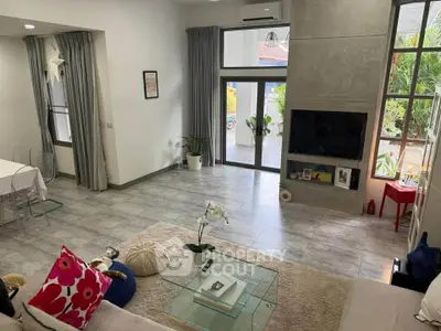 Spacious modern living room with large windows and stylish decor