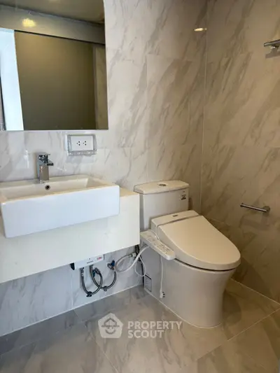 Modern bathroom with sleek fixtures and marble tiles