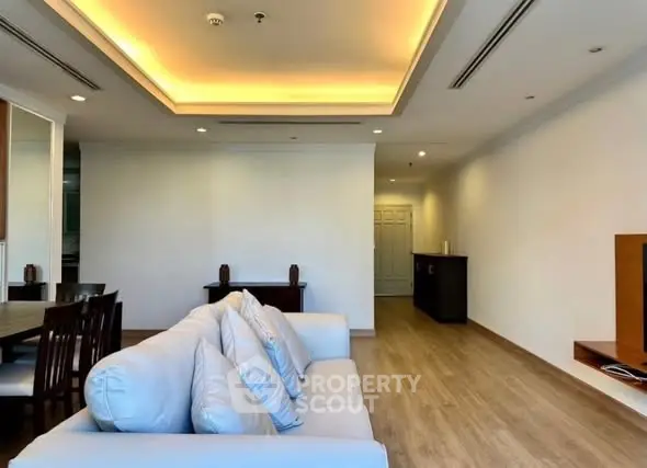 Spacious modern living room with elegant lighting and wooden flooring