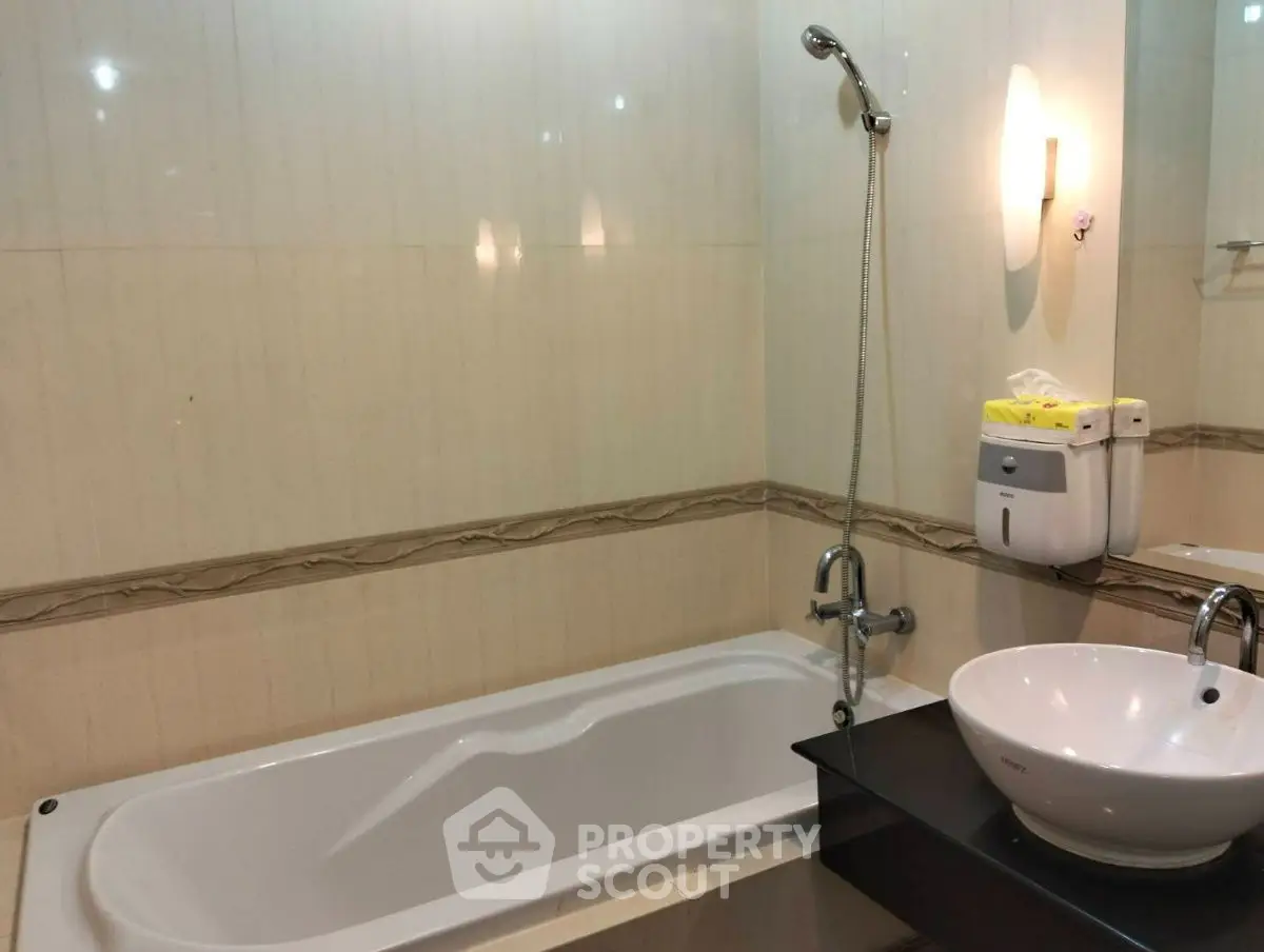 Elegant bathroom with modern fixtures and a sleek bathtub design.