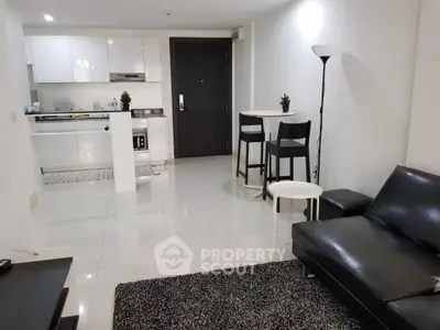 Modern open-plan living room with sleek kitchen and stylish furnishings