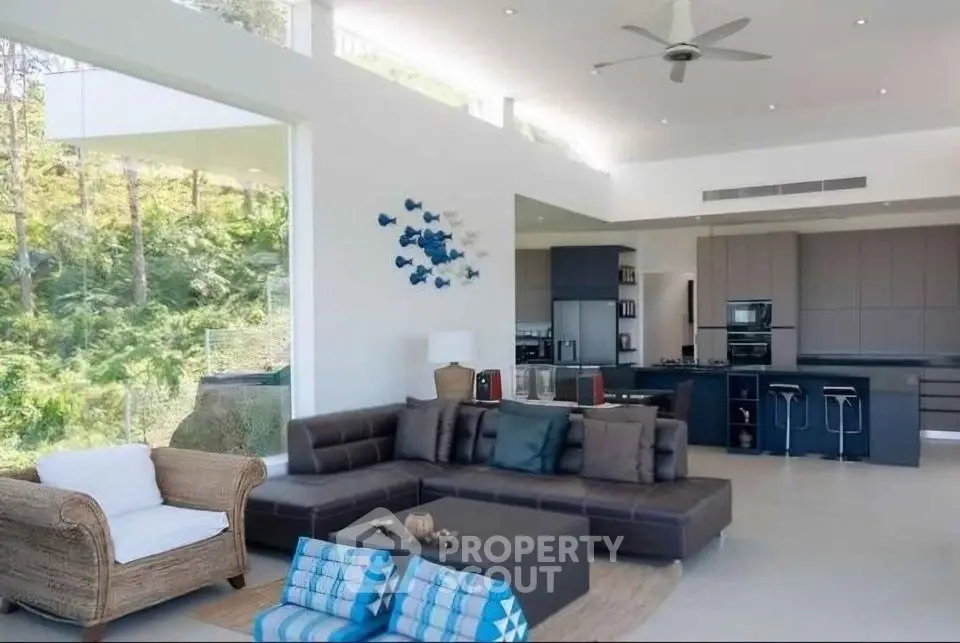 Luxurious open-plan living room with modern kitchen and scenic views
