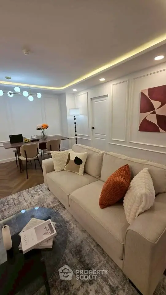 Elegant living room with modern decor, cozy sofa, stylish dining area, and ambient lighting for a luxurious feel.