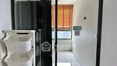 Modern kitchen with sleek appliances and sliding glass door, featuring ample natural light and storage solutions.