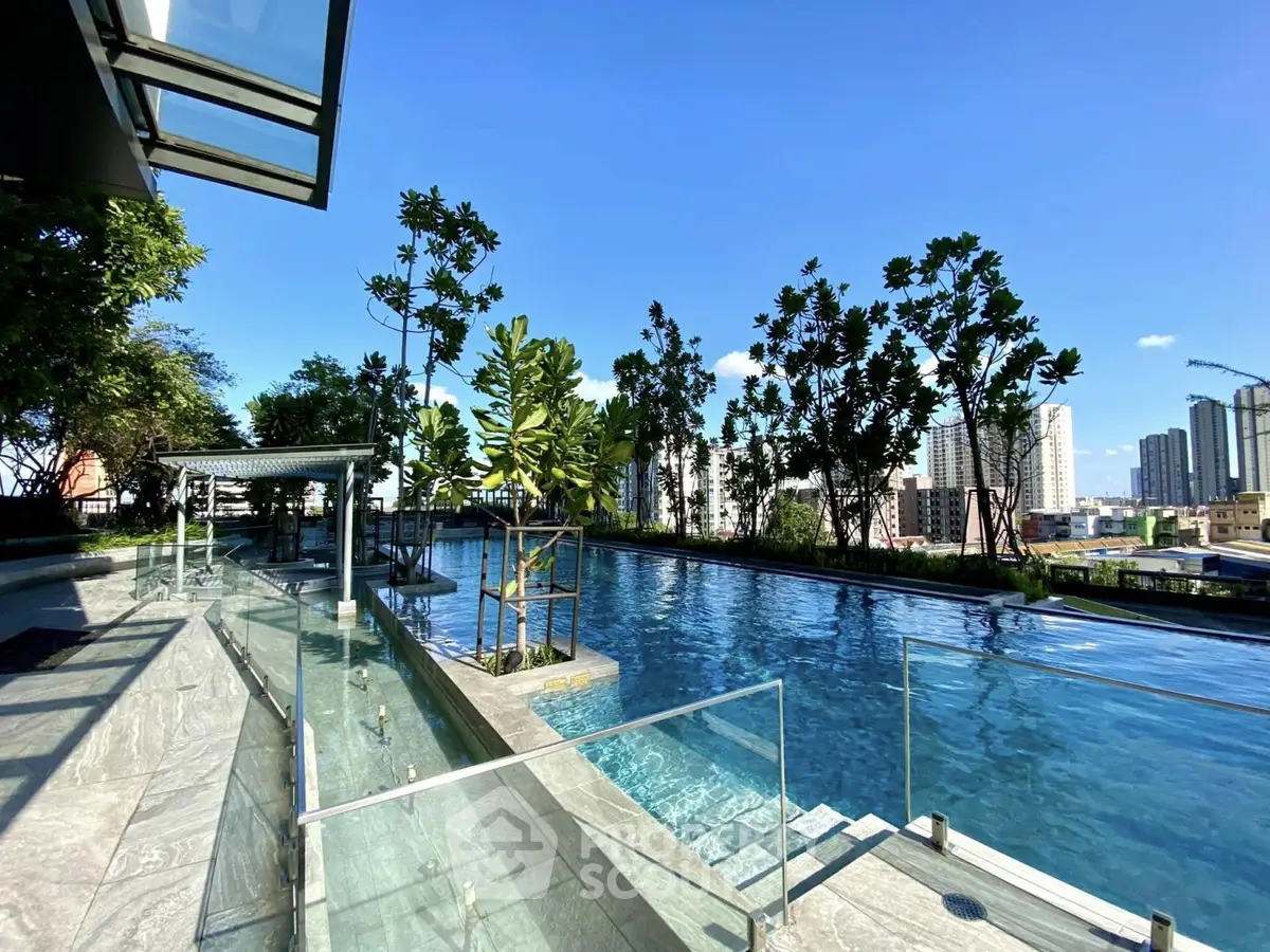 Luxurious rooftop pool with stunning city skyline views and lush greenery, perfect for relaxation and leisure.