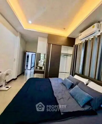 Spacious modern bedroom with elegant lighting and air conditioning, perfect for comfort and relaxation.