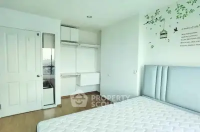 Bright and airy bedroom with minimalist decor and large window view.