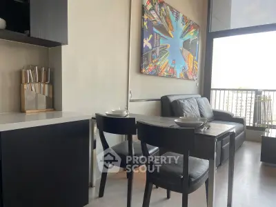 Modern living room with stylish decor and city view balcony in urban apartment.
