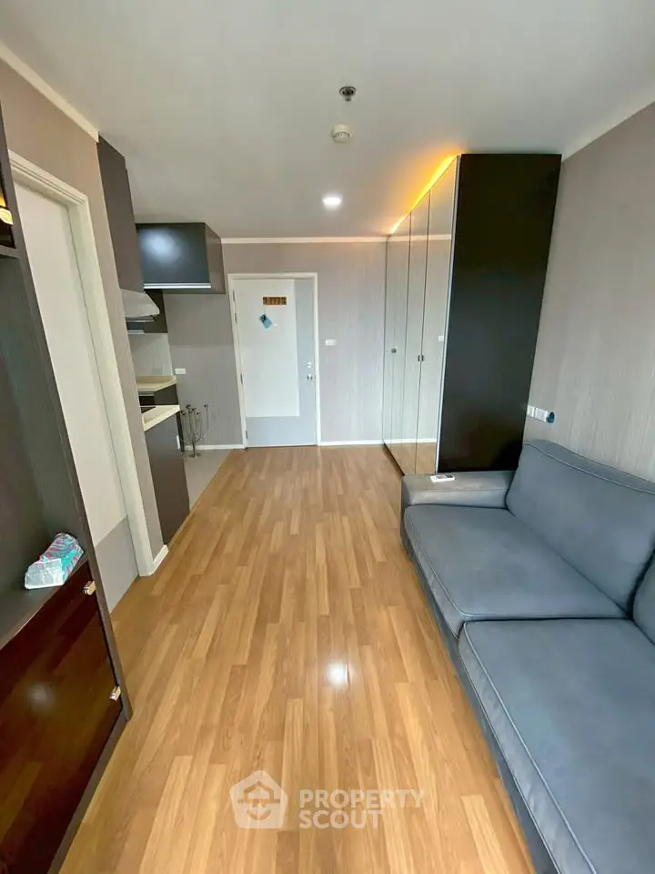 Modern living room with sleek wooden flooring and stylish furniture