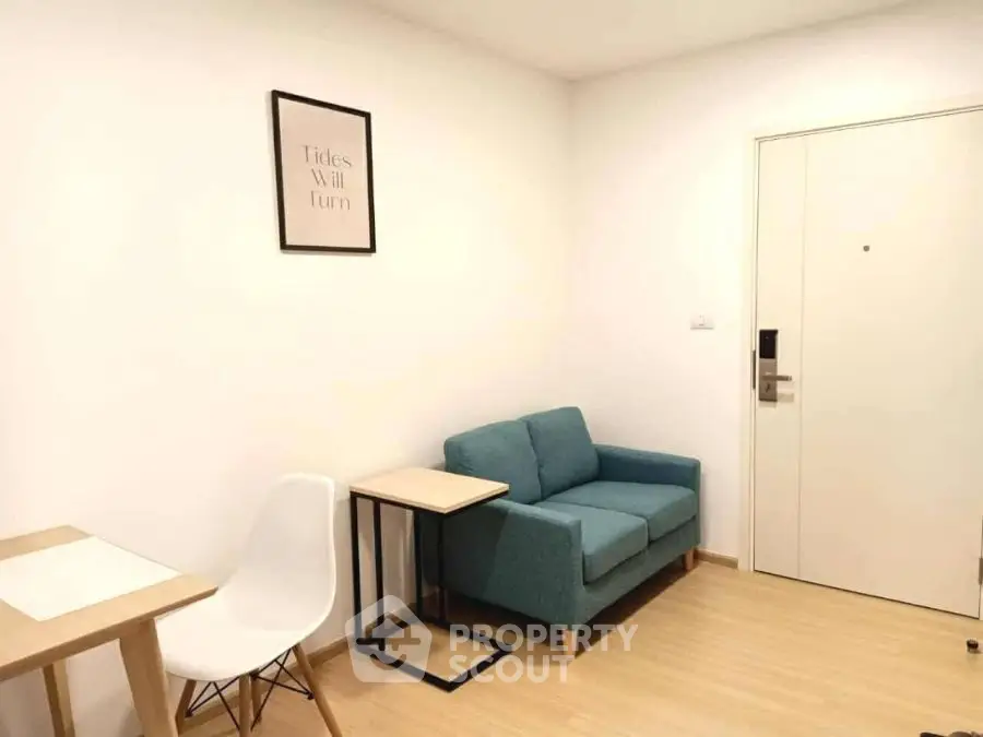 Cozy minimalist living room with modern furniture and light wood flooring.