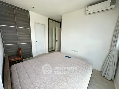 Modern bedroom with sleek wardrobe and air conditioning unit