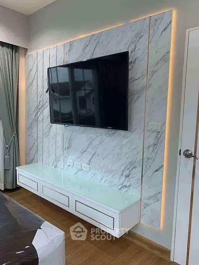 Modern living room with marble accent wall and mounted TV