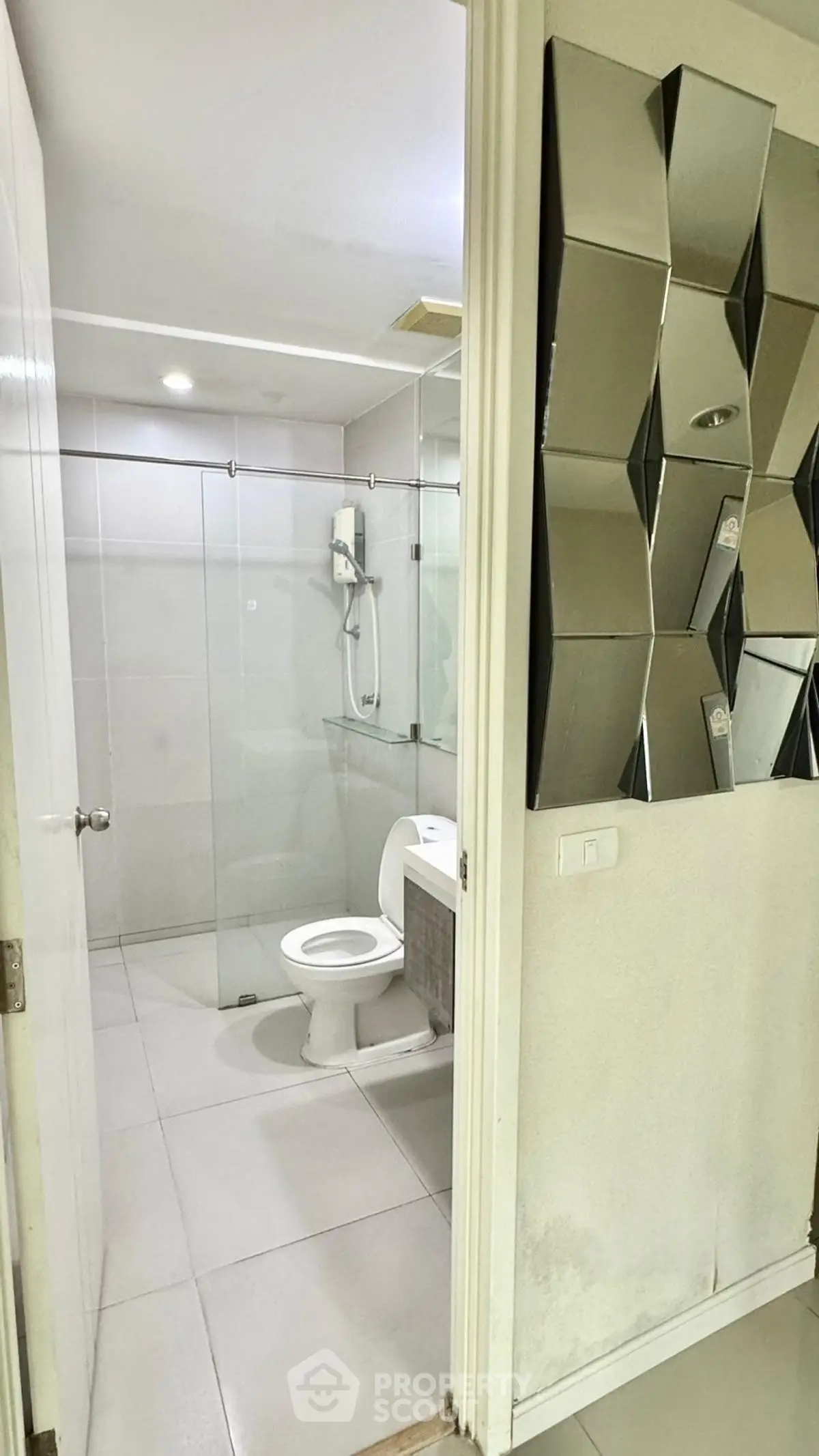 Modern bathroom with glass shower and unique wall mirror design