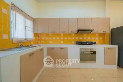 Modern kitchen with yellow tile backsplash and built-in oven, perfect for culinary enthusiasts.