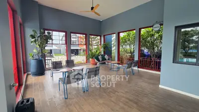 Spacious modern balcony with stylish seating and vibrant decor, perfect for relaxation and entertainment.