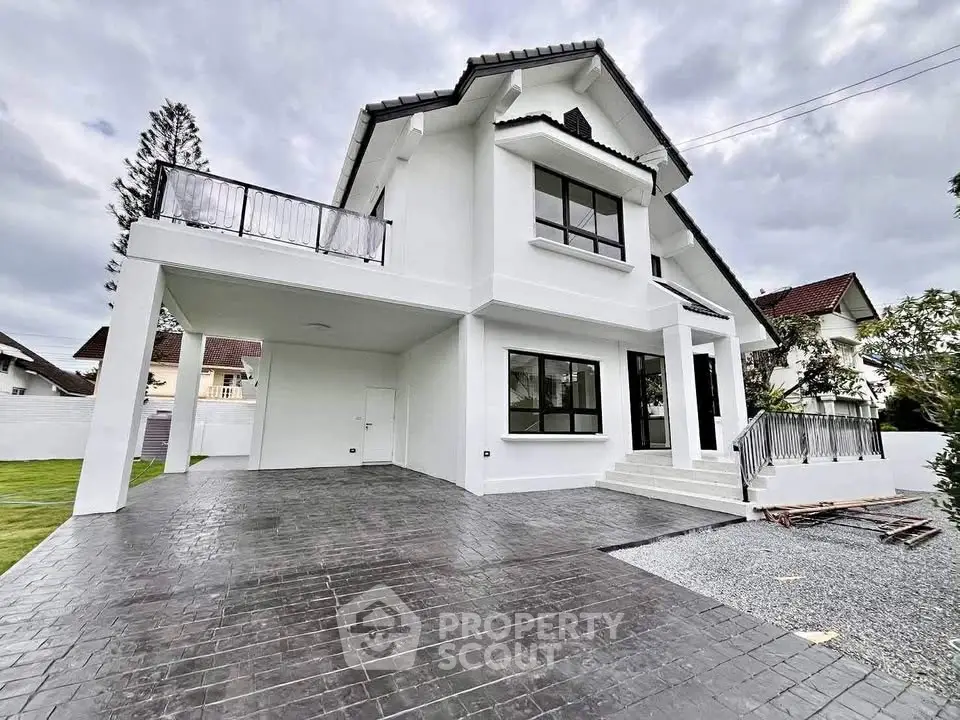 Stunning modern white house with spacious driveway and elegant balcony.