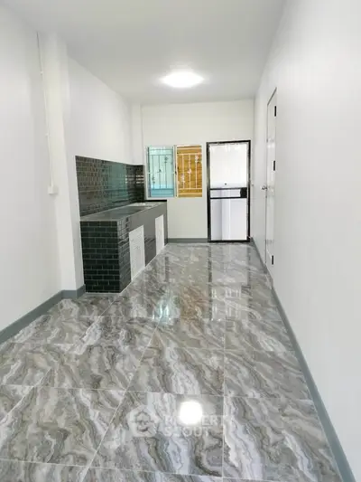 Sleek modern kitchen with glossy marble tiles and stylish backsplash