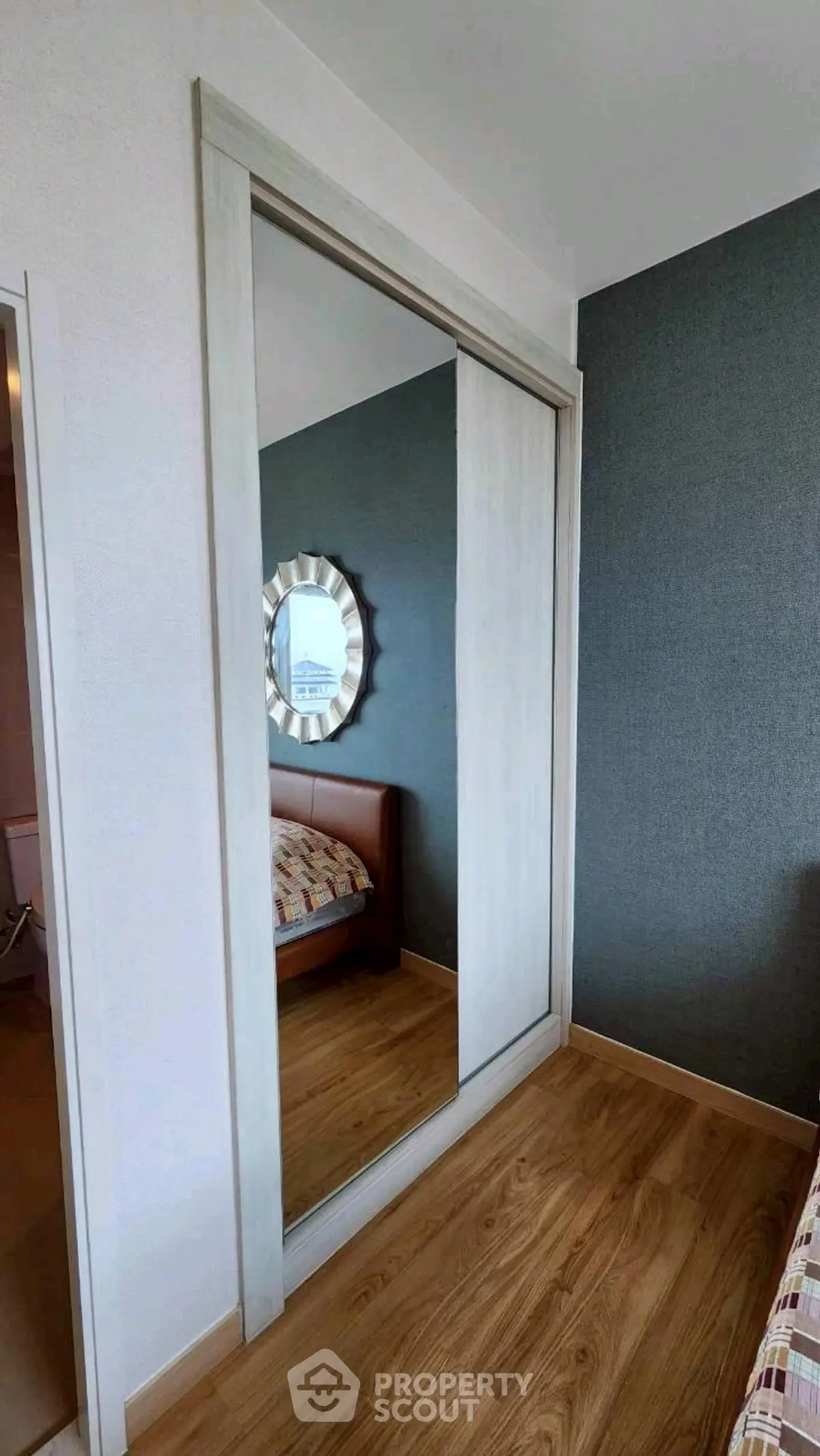 Modern bedroom with mirrored sliding closet doors and stylish decor