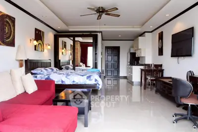 Spacious open-plan living room with modern decor and kitchen area