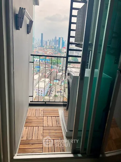 Charming balcony with city view and washing machine, perfect for urban living.