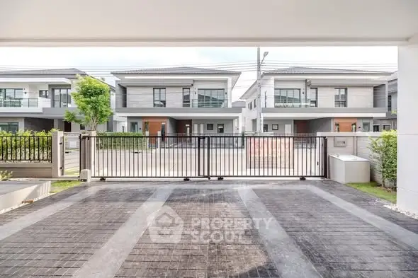 Modern residential neighborhood with gated entrance and contemporary houses.