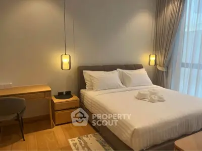 Elegant bedroom with cozy lighting and modern furnishings, perfect for relaxation and comfort.