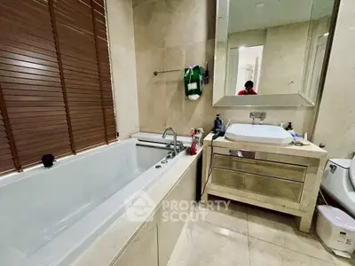 Luxurious bathroom with modern fixtures and spacious bathtub in elegant real estate property.