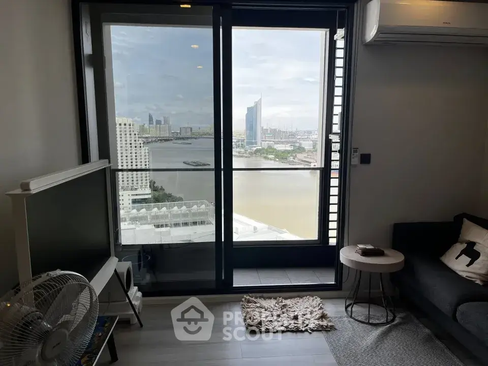 Modern living room with stunning city and river view from balcony, featuring sleek furniture and air conditioning.