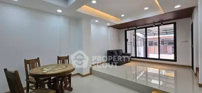 Spacious modern living room with elevated seating area and large windows