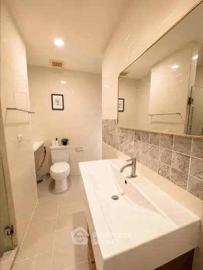 Modern bathroom with sleek fixtures and elegant tile design, perfect for a contemporary home.