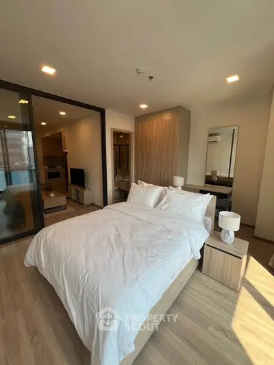 Modern bedroom with elegant decor and natural light in a stylish apartment.