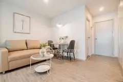 Modern living room with cozy sofa and dining area in open layout.